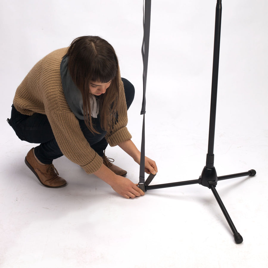 Adjustable Boom Stop being mounted on a boom arm stand leg